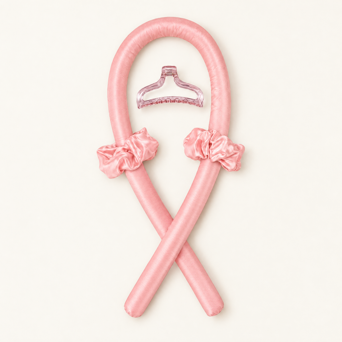 Pink heatless curling kit with one padded rod, two scrunchies and a claw clip